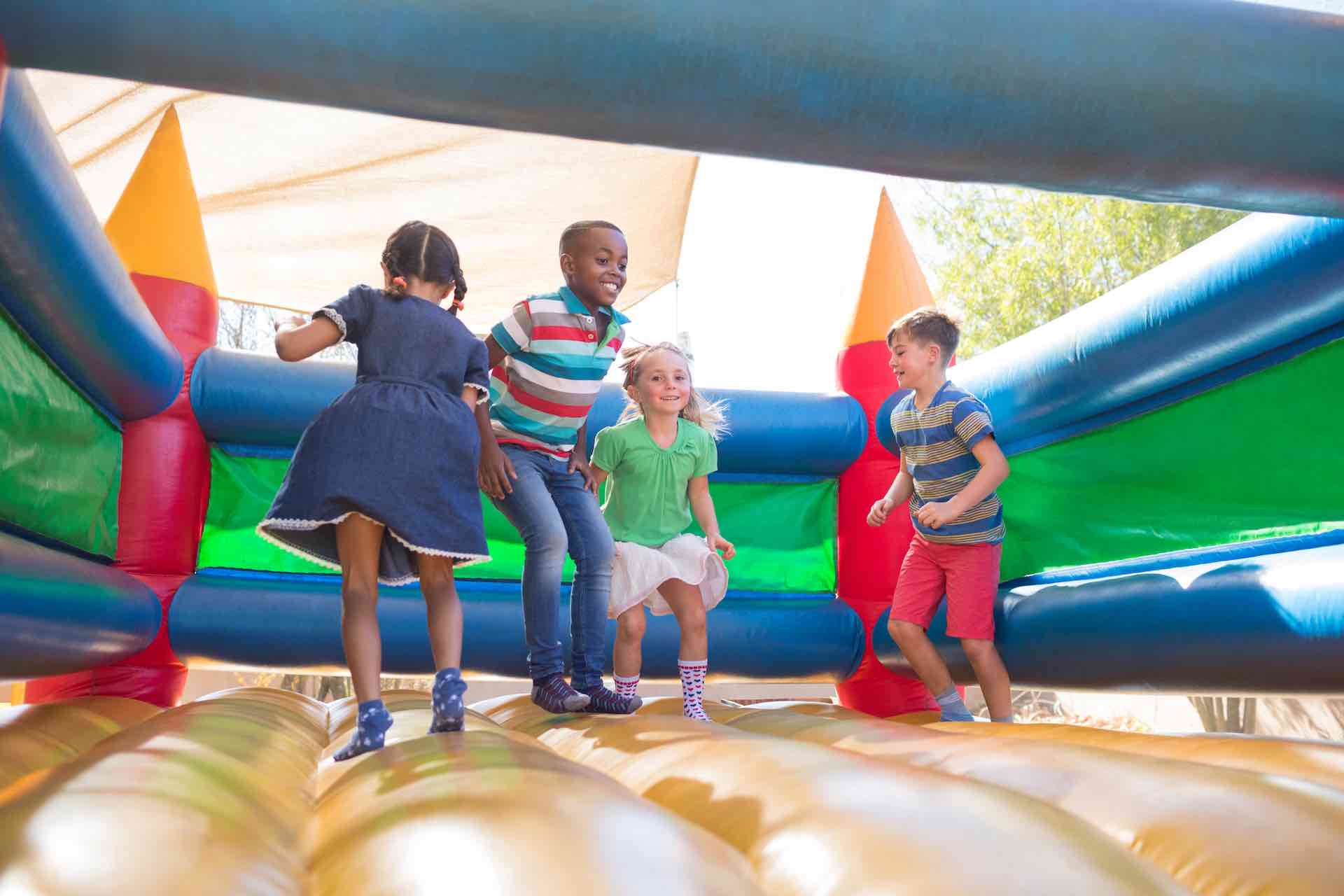 Kids playing in a bounce house at a local party